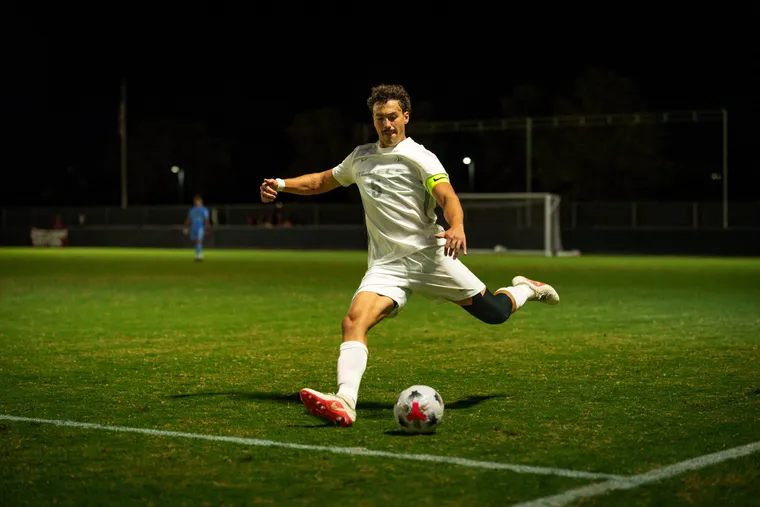 Manuel, wearing the UNLV captain's armband, striking the ball during a night match